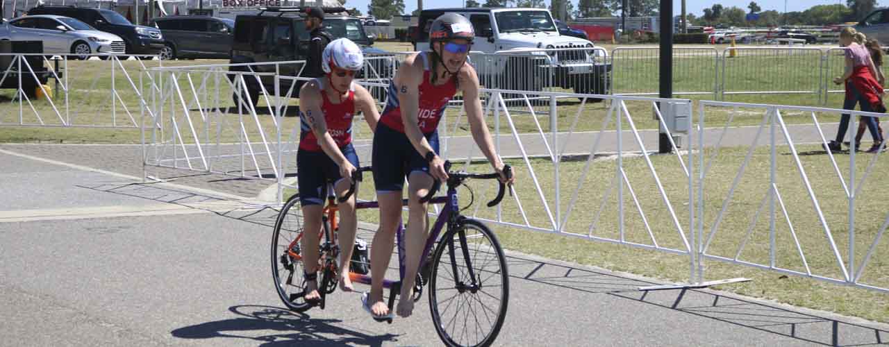 Cedarville Alumna Deborah Chucoski riding a tandem bike while racing in a triathlon.