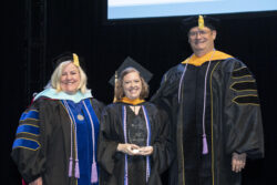 female graduate receiving award